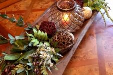 13 a bread bowl with wicker balls, acorns, greenery and white blooms as a centerpiece