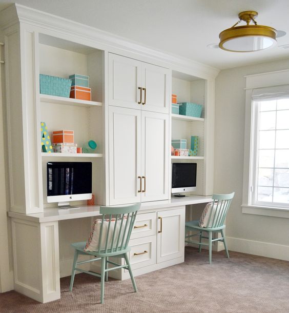 a vintage-inspired study space with white cabinetry and desks integrated into it