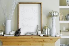 14 a modern mantel with silver pumpkins, pinecones, antlers and a sign looks fresh