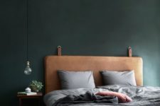14 a moody bedroom with dark green walls and a brown leather headboard for a man