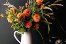 14 orange dahlias, greenery and grass, wheat and lavender in a jaug for a rustic feel