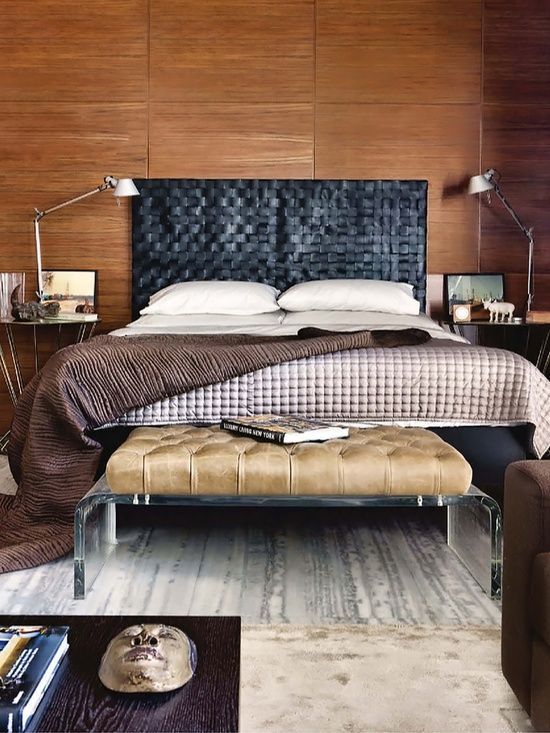 a stylish masculine bedroom with a black woven leather headboard and a leather bench