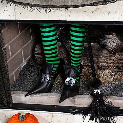 faux witch's legs in shoes and striped stockings look freaky