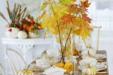 16 a natural tablescape with fall leaves and pumpkins, sheer vases and glasses