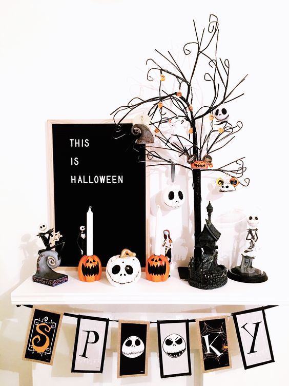 Halloween Tim Burton decor with a banner, some candleholders, a tree with ornaments and a sign is a cool idea