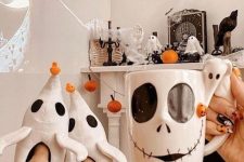 Nightmare Before Christmas decor with pumpkins, ghosts, a fall wreath with bats, some carved pumpkins and themed stuff