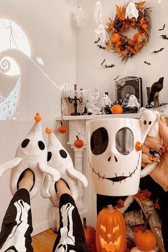 Nightmare Before Christmas decor with pumpkins, ghosts, a fall wreath with bats, some carved pumpkins and themed stuff