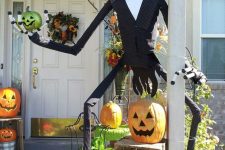 Nightmare Before Christmas porch decor with jack-o-lanterns, Jack Skellington and some greenery is bold and fun