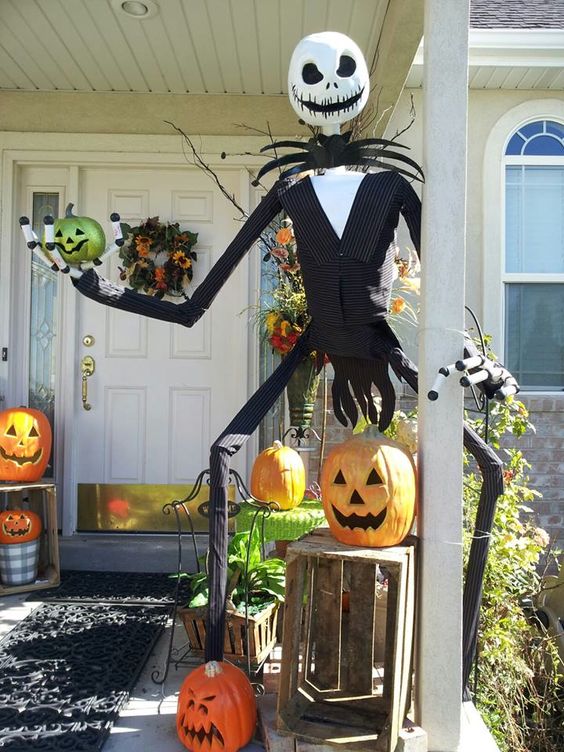 Nightmare Before Christmas porch decor with jack-o-lanterns, Jack Skellington and some greenery is bold and fun