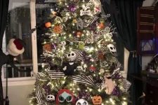 a Christmas tree with lights, Nightmare Before Christmas ornaments, striped ribbons, shiny branches and twigs and a hat on top
