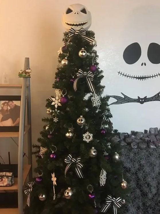 a Christmas tree with purple and gold ornaments and bows plus Jack Skellington decorations for more chic