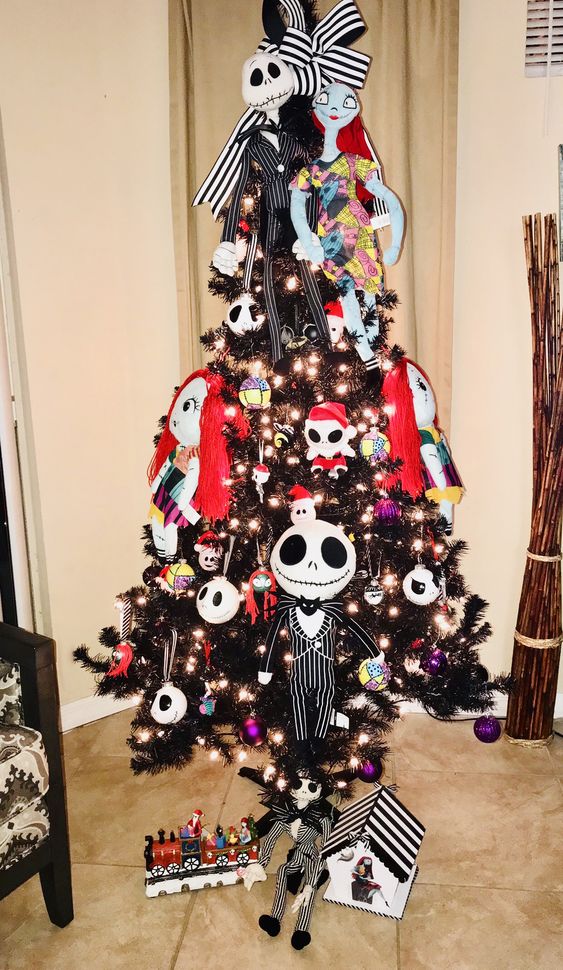 a Halloween tree with Jack Skellington and Sally dolls, lights, ornaments and ribbons is amazing