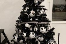 a black Halloween tree with Jack Skellington ornaments and striped ones, with ribbons and a creative tree topper