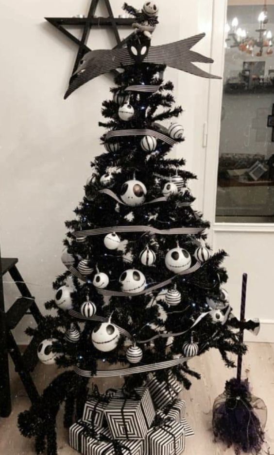 a black Halloween tree with Jack Skellington ornaments and striped ones, with ribbons and a creative tree topper