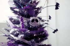 a purple Halloween tree with matching ribbons, Jack Skellington head, bats and lights is a gorgeous idea to rock at Halloween