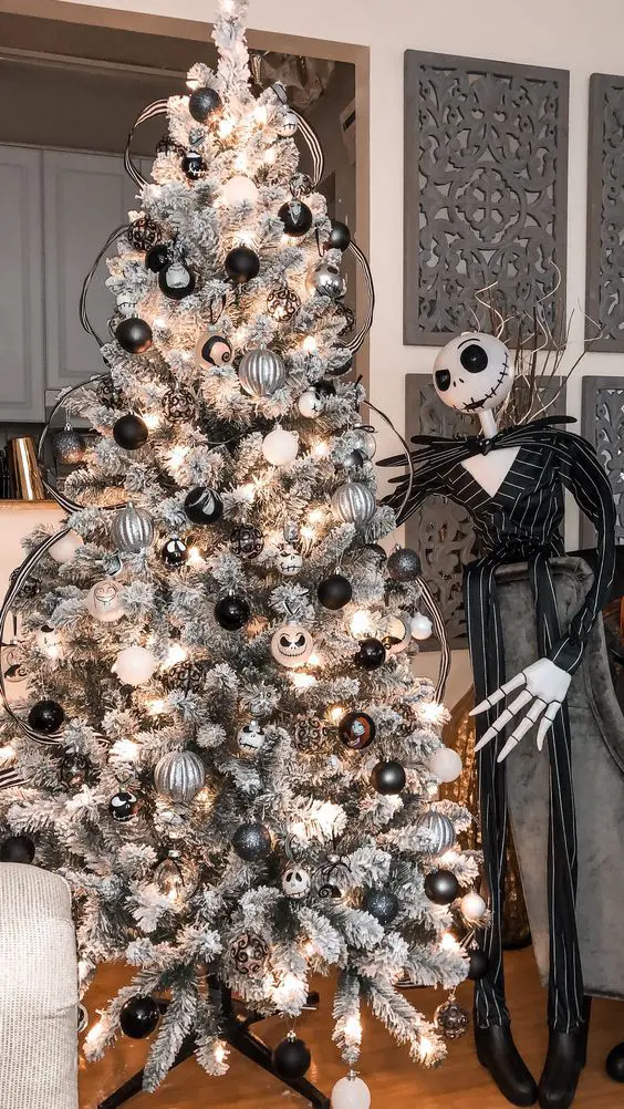 a snowy Christmas tree with black and white ornaments, lights, themed ornaments and Jack Skellington will be great for Halloween or Christmas