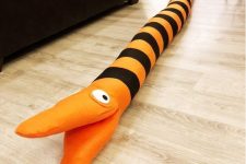 an orange and black striped Halloween decoration – a Nightmare Before Christmas tree eating snake