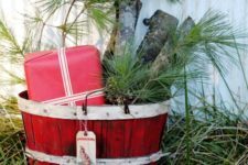 02 a bushel basket in red, pine branches, logs and a gift wrapped in red paper