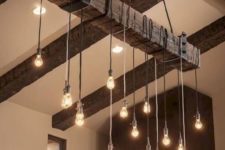 04 a reclaimed wooden beam with metal detailing and bulbs hanging on cords for a masculine space
