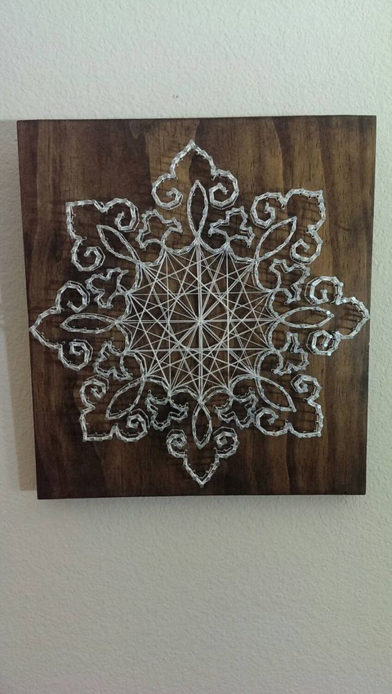 a gorgeous lace snowflake string art in white looks refined and very chic