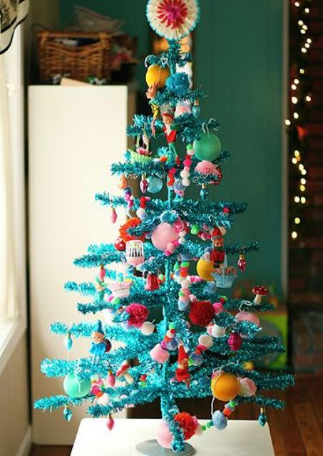 a shiny turquoise pipe cleaner tree with super bold ornaments for a kids' space