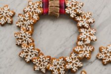 06 an edible wreath of iced gingerbread cookies shaped as snowflakes can be used for decor, too