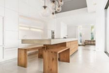 07 a minimalist concrete kitchen island with an eating space and benches under it