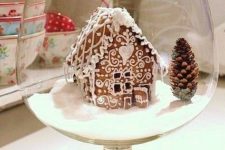 08 a Christmas terrarium with a glazed gingerbread house, fake snow and a pinecone