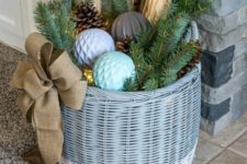 09 a basket with Christmas ornaments, firewood, evergreens and pinecones, LEDs inside
