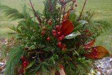 10 a lush basket with evergreens, berries, foliage and festive ribbons for outdoor decor