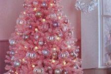 10 a pink Christmas tree with pastel ornaments and lights