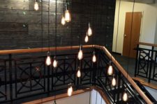 10 highlight your high ceilings and a staircase with a large black metal tubing and bulbs on cords