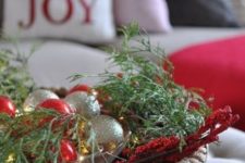 11 a basket with Christmas ornaments, greenery and berries for indoor decor