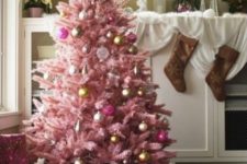 11 a pastel pink Christmas tree with metallic and fuchsia ornaments