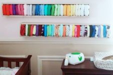 box shelves with different colorful diapers over the changing table