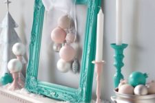 12 a turquoise frame with ornaments and some candle holders for modern decor