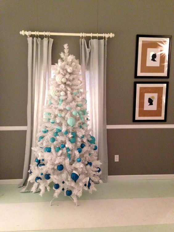 a white Christmas tree with gradient ornaments from white to navy