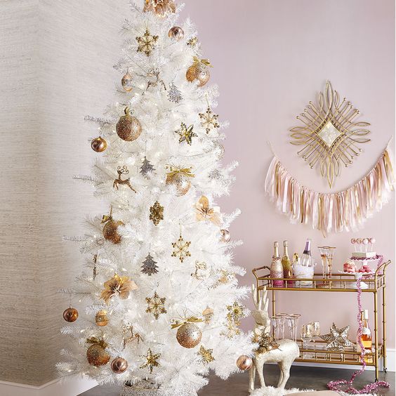 a white tree with gold and gold glitter ornaments create a very refined look