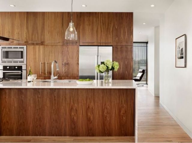 rich-colored sleek wooden cabinets with white marble countertops for a refined look