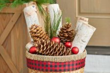 13 a basket with large pinecones, Christmas ornaments and birch logs for a holiday feel