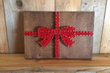 13 a gift with a red ribbon bow string art will add a whimsy touch