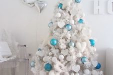 13 a white tree with white ornaments and some bold turquoise and blue ones to make it stand out