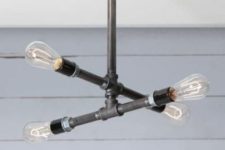 13 an industrial black pipe chandelier with four bulbs looks very laconic and clear