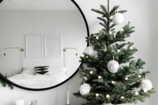 15 a small tree with white pompom garlands and large fluffy pompom ornament