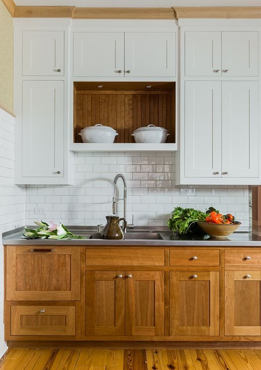 wooden and white cabinets make up a trendy two-toned look with a rustic feel