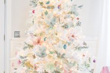 a dreamy white Christmas tree with lights, leaves, faux blooms and pastel ornaments is a catchy idea