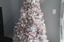 a glam white Christmas tree with pink, blush and white ornaments and pink ribbons is amazing