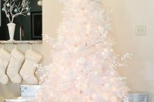 a lovely white Christmas tree with lights, berries and white ornaments plus a light star topper is a gorgeous idea to try