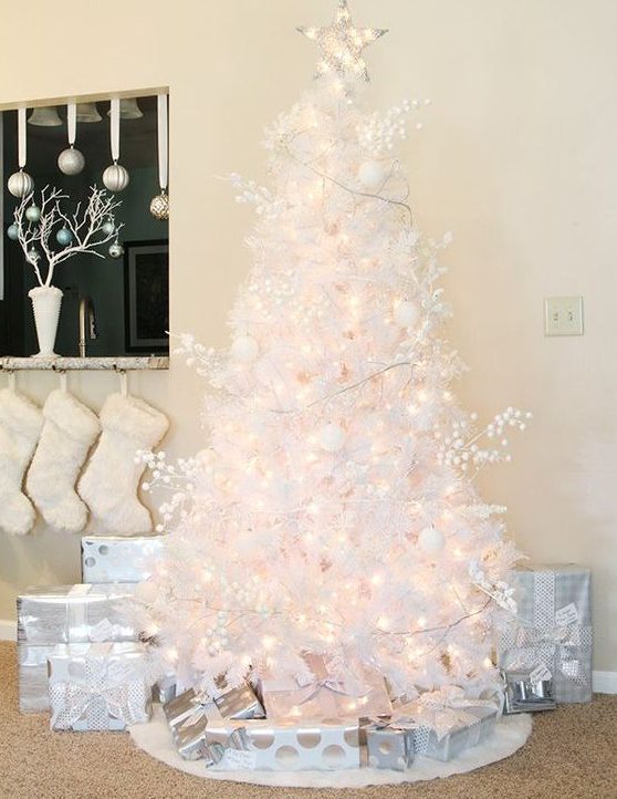 a lovely white Christmas tree with lights, berries and white ornaments plus a light star topper is a gorgeous idea to try