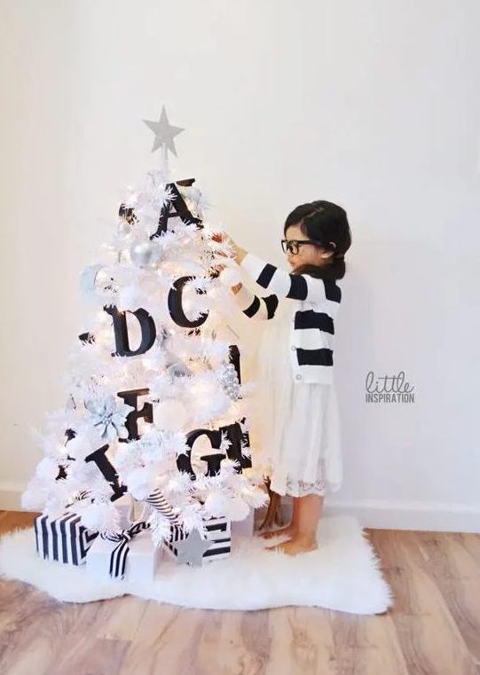 a small white Christmas tree decorated with black letters will help your kids learn them - make such a space for your kids' room